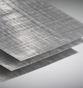 Close-up of three thin, gray composite sheets with a woven crosshatch texture, stacked.
