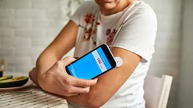 female checking her glucose levels