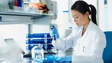 Scientist pipetting samples into eppendorf tubes in research laboratory