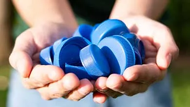 Person holding blue beverage caps
