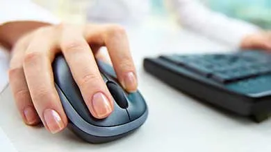 Close up on female hand using computer mouse