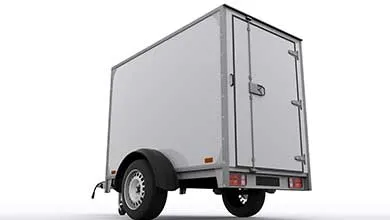 Rear three-quarter view of a white, single-axle enclosed cargo trailer on a white background.
