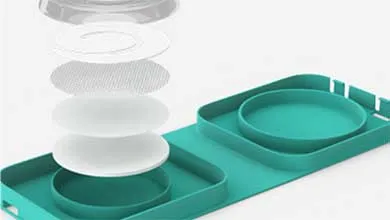 Exploded diagram of a product showing a clear top, mesh filter, and other layers above a teal base with circular compartments.