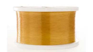 Close-up of a white spool wrapped with shiny golden-yellow thread.